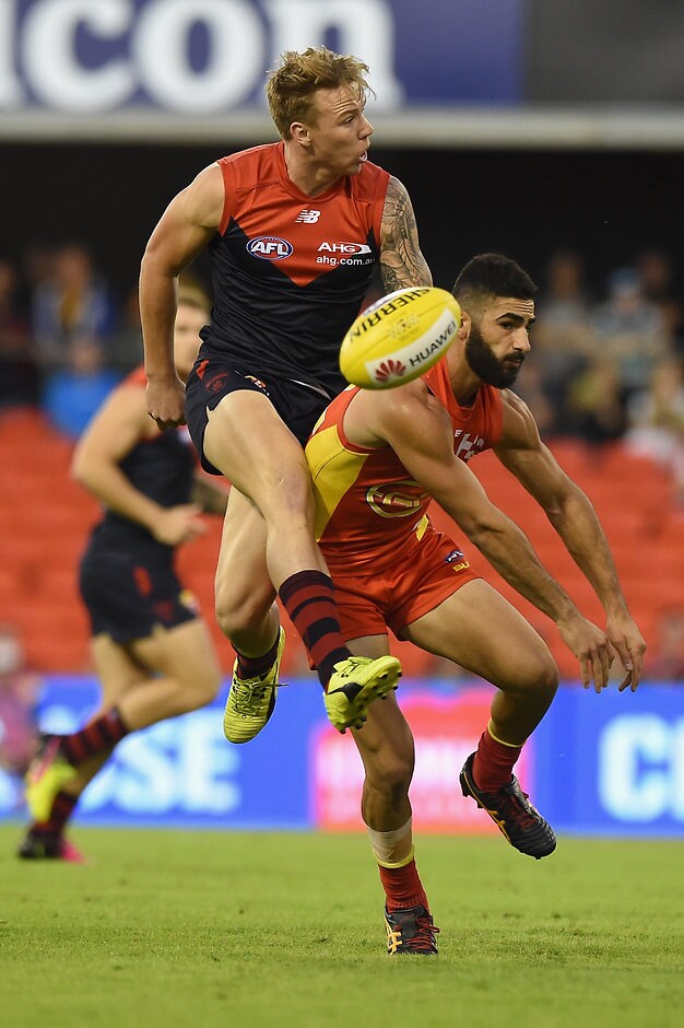 AFL 2016 Rd 07 - Gold Coast v Melbourne GOLD COAST, AUSTRALIA - MAY 7: Adam Saad of the Suns spoils the kick of James Harmes of the Demons during the 2016 AFL Round 07 match between the Gold Coast Suns and the Melbourne Demons at Metricon Stadium, Gold Coast on May 7, 2016. (Photo by Matt Roberts/AFL Media)